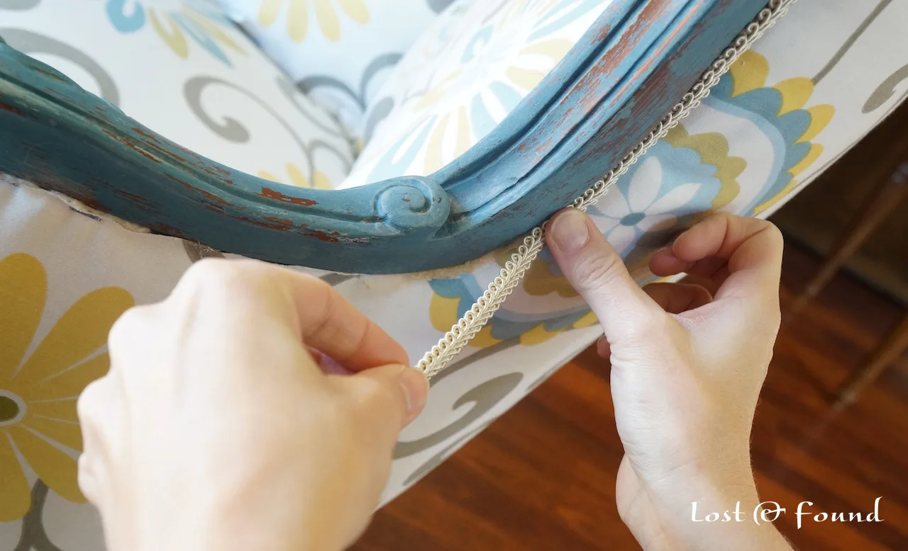 Use trim to cover rough edges of reupholstered chair