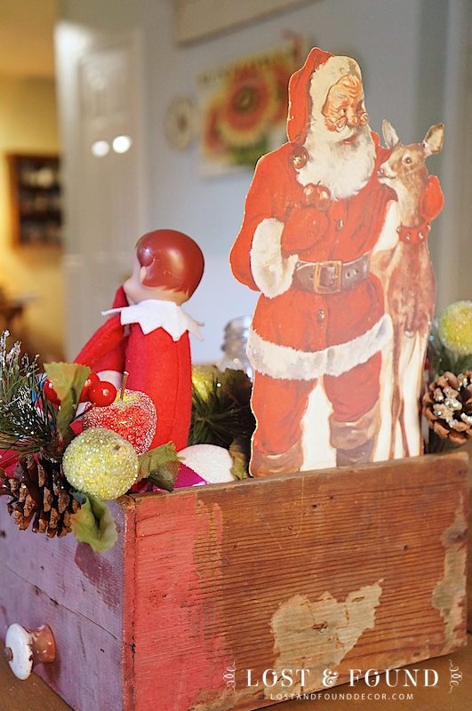 Gather together Christmas themed decor in primitive box for a fun display