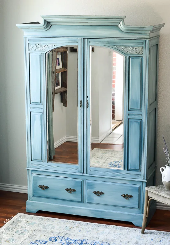 armoire painted in multiple shades of blue