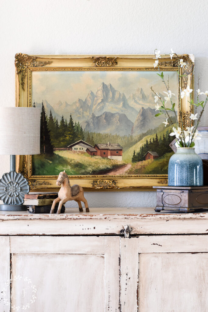landscape painting over entryway cabinet