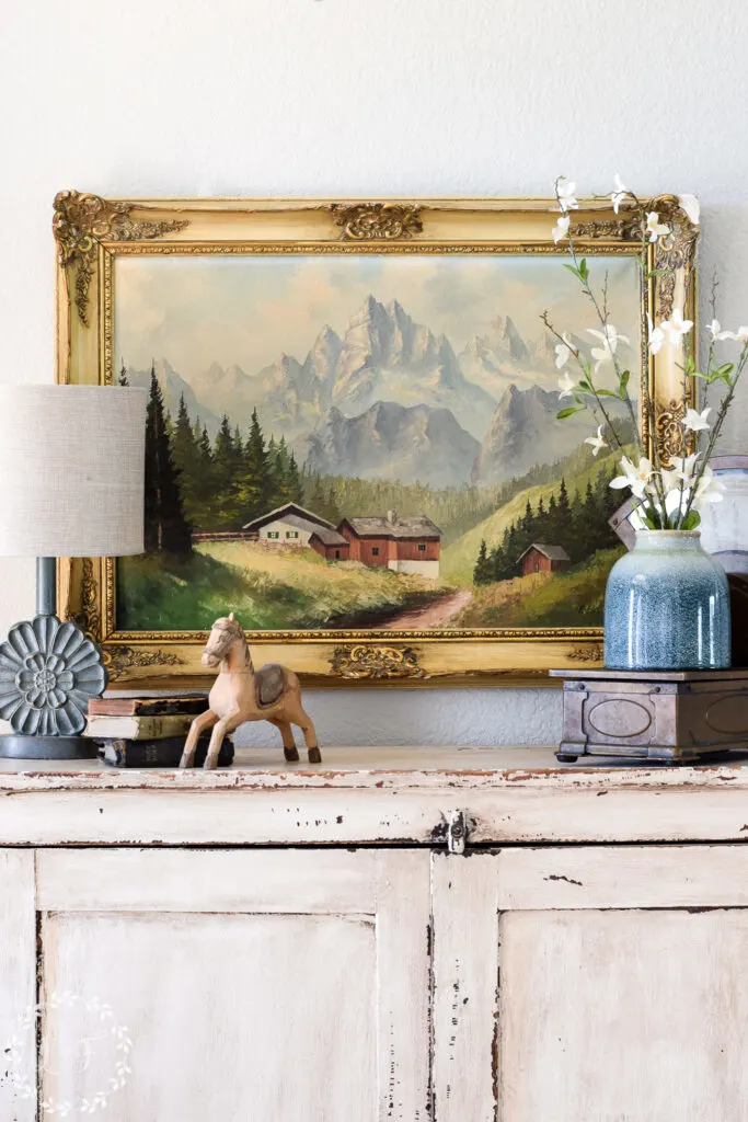landscape painting over entryway cabinet