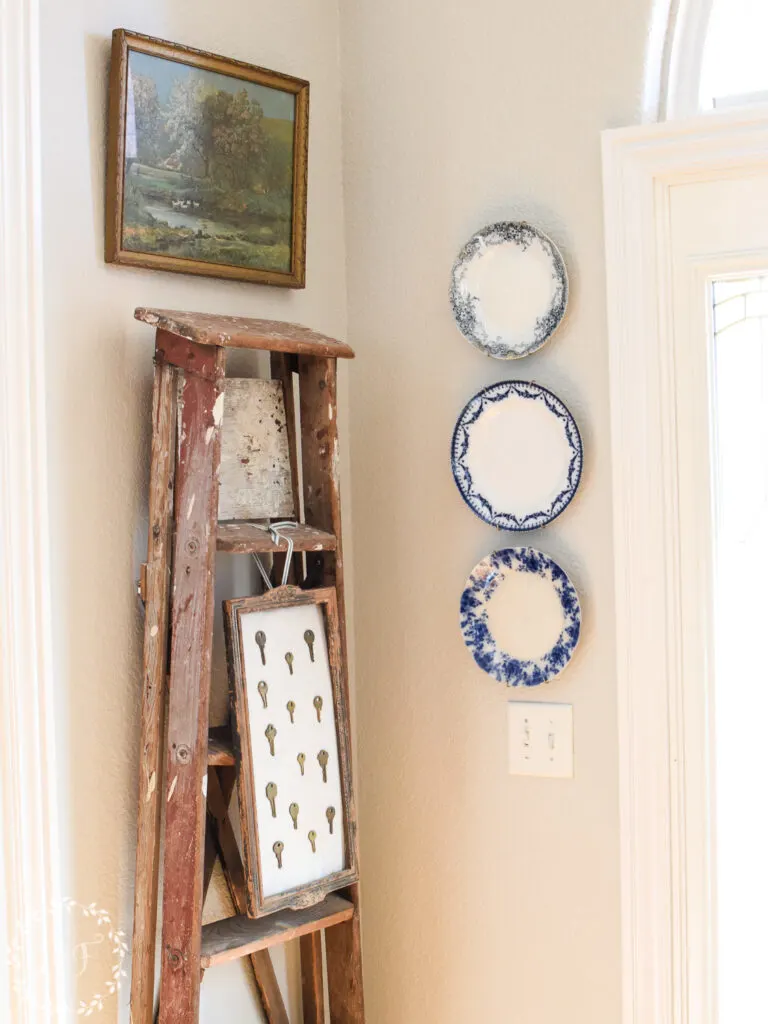 old ladder with plates hanging on the wall