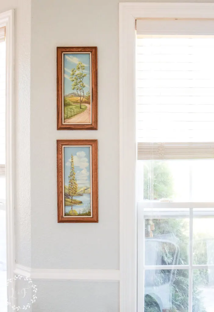 vintage paintings on a wall in a kitchen