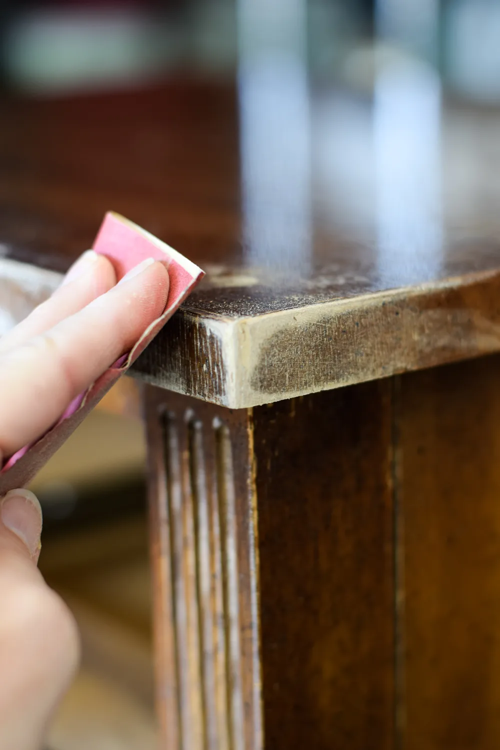 sanding a piece of furniture smooth
