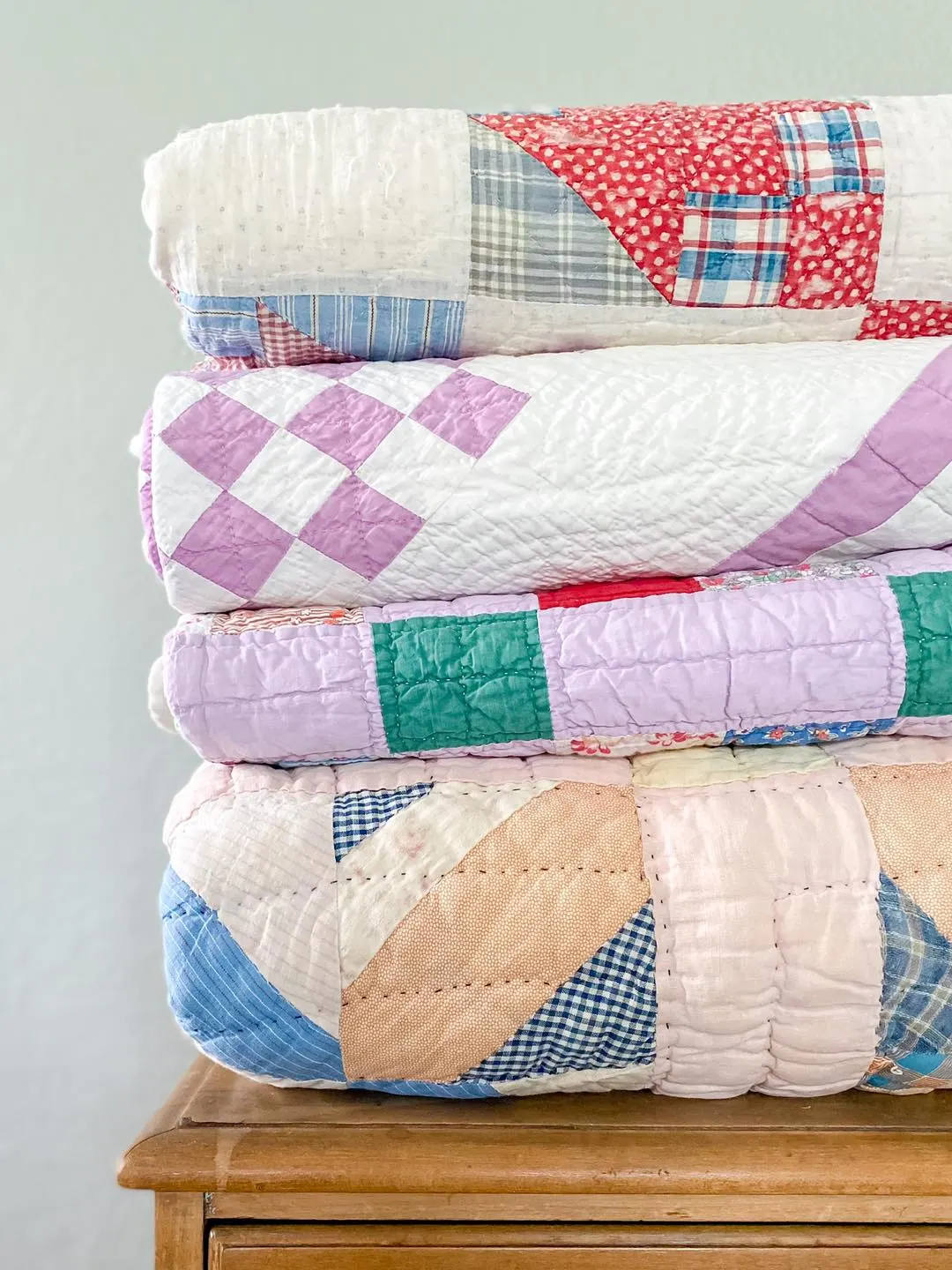 stack of vintage quilts